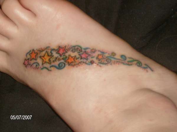 Freehanded stars on foot tattoo