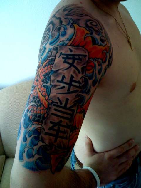 Koi with waves and kanji tattoo
