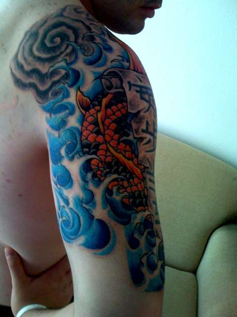 koi with waves and kanji tattoo