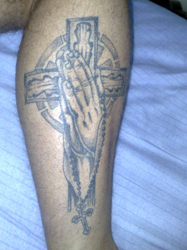 Cross and praying hands tattoo