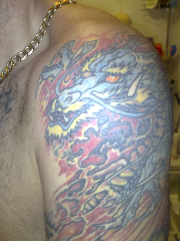 Top of left arm sleeve tattoo