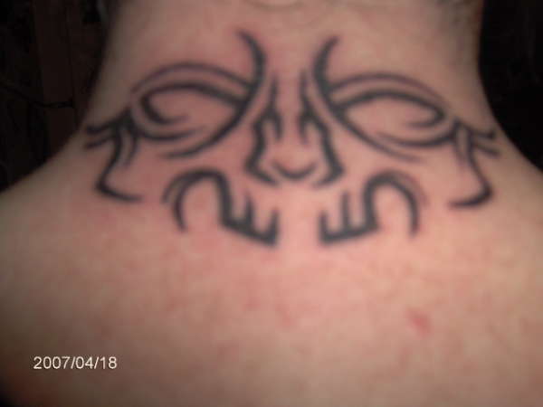 tribal skull face tattoo