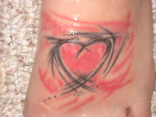 Heart on foot tattoo