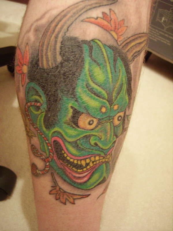 Green mask tattoo
