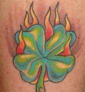 Flaming 4 leaf clover tattoo