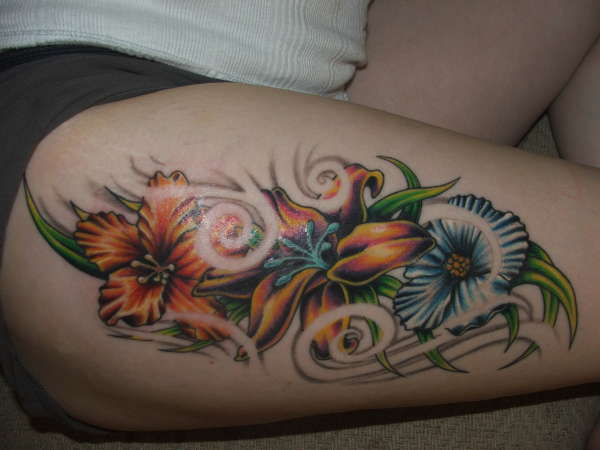 Flowers on her leg tattoo
