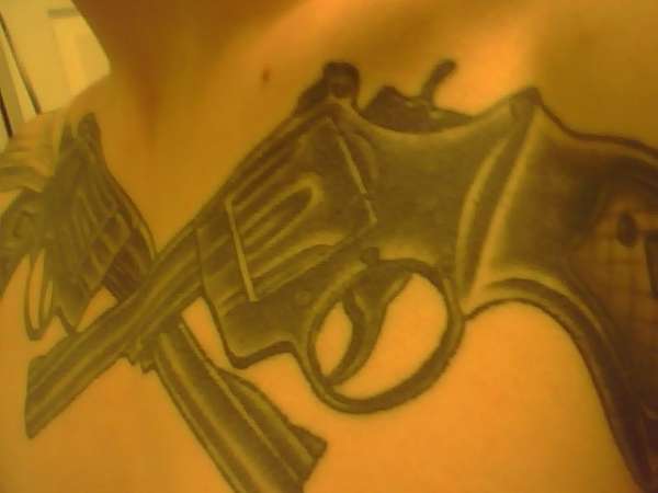 big guns on chest tattoo