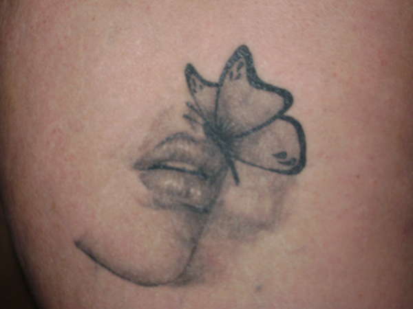 Butterfly lip tattoo