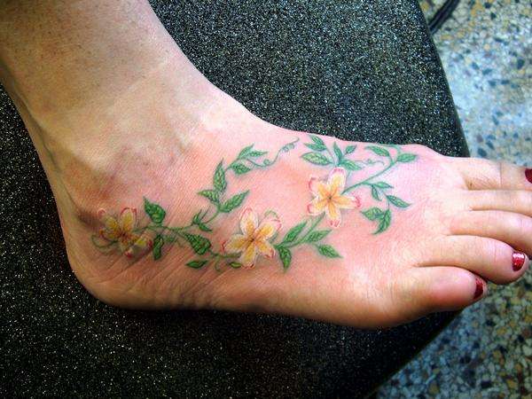 Flowering vine on foot tattoo