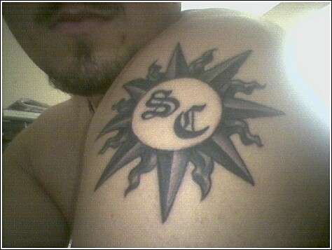 Sun and initials tattoo