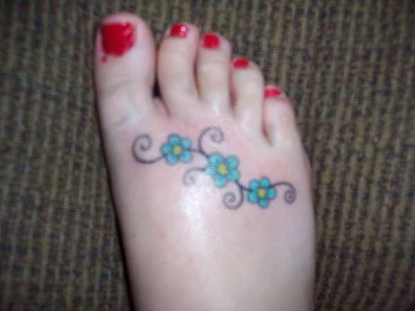 flowers on foot tattoo