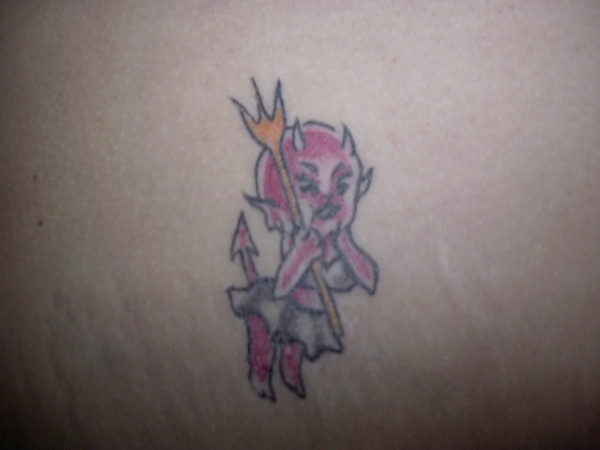 little devil on breast tattoo