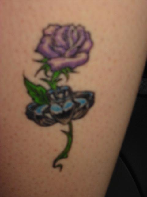 Purple rose with irish claddagh ring tattoo