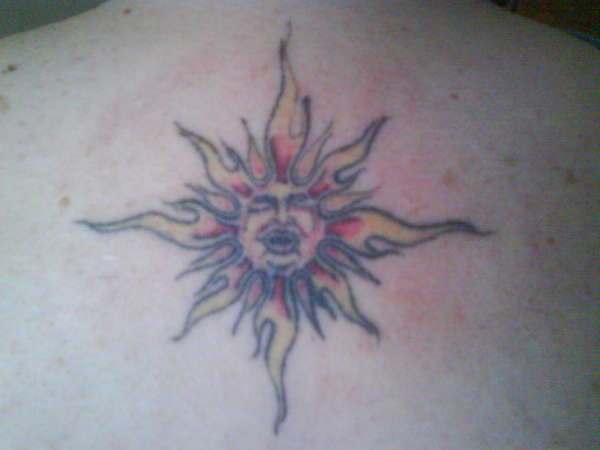 my wifes sun on her back tattoo