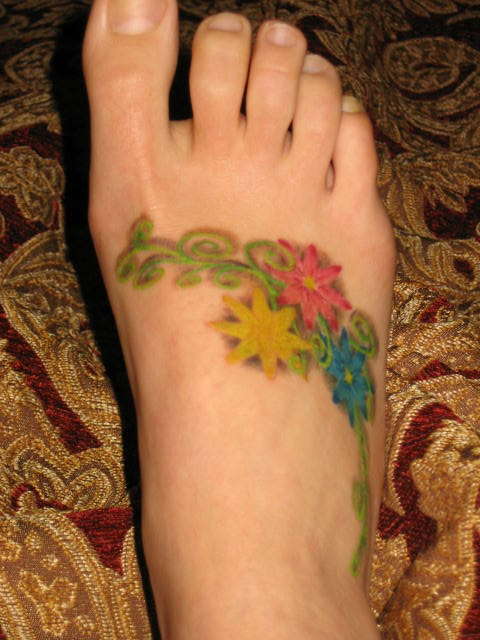 flowers on top of foot tattoo