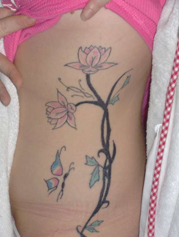 tribal with lily's and butterflie tattoo