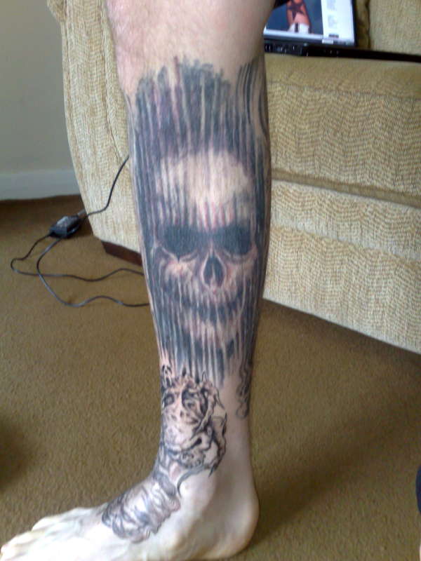 big skull on shin tattoo