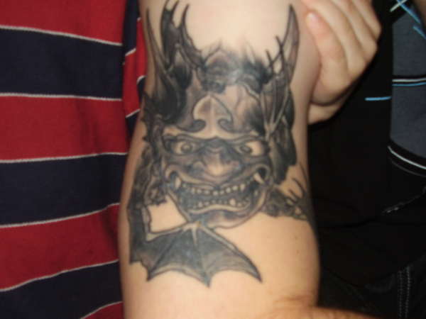 dragon mask with bats tattoo