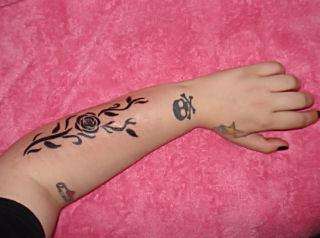 vine & 1 rose on left arm tattoo