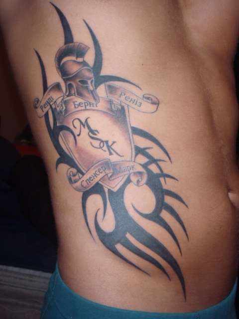 Family Ukrainian writing and black art tattoo