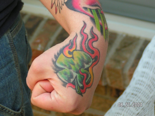 Flaming shamrock cover tattoo