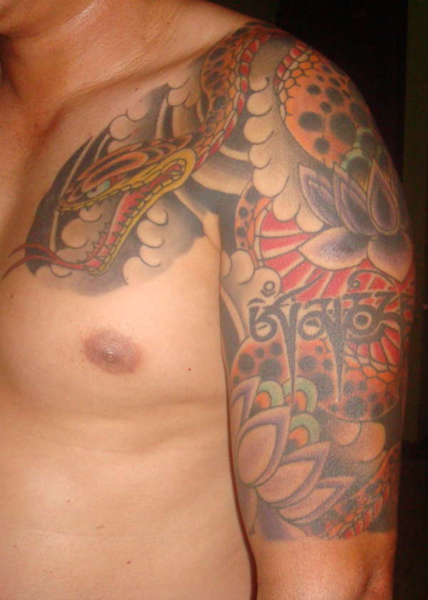 Snake with lotus flowers tattoo