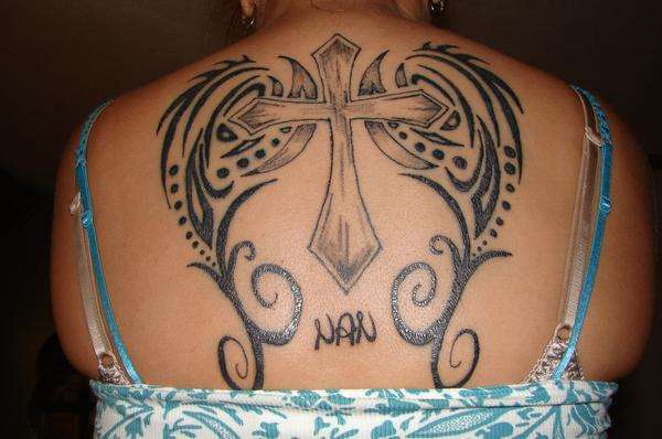 Tribal wings & cross tattoo