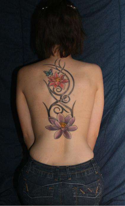 Lotus flowers and Tribal backpiece tattoo