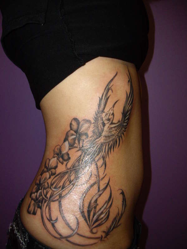 Phoenix and Orchid Rib Tattoo tattoo