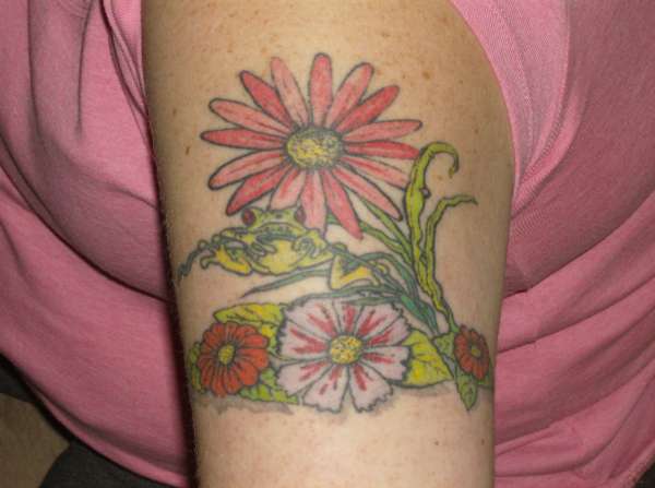 Free hand frog and flowers on my wife's arm. tattoo