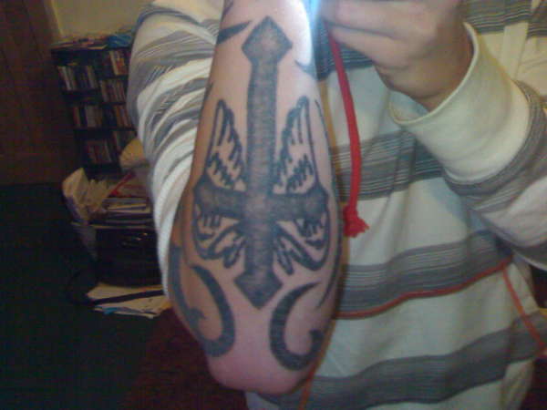 Cross forearm tattoo