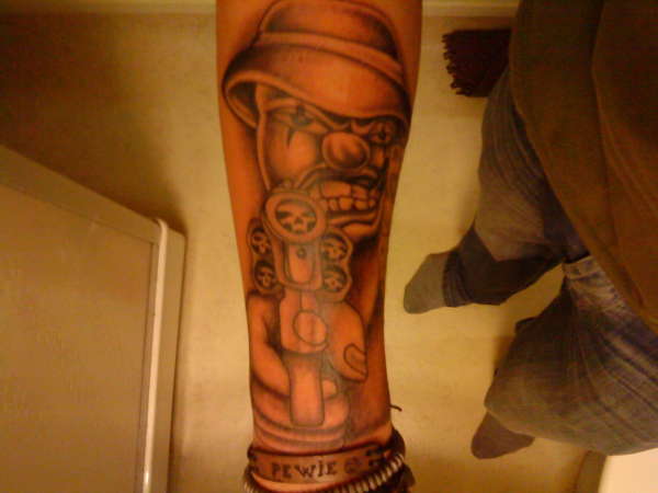 Joker with gun tattoo