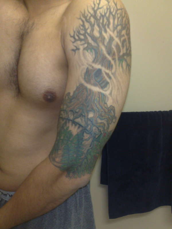 Tree on pillar with leaves tattoo