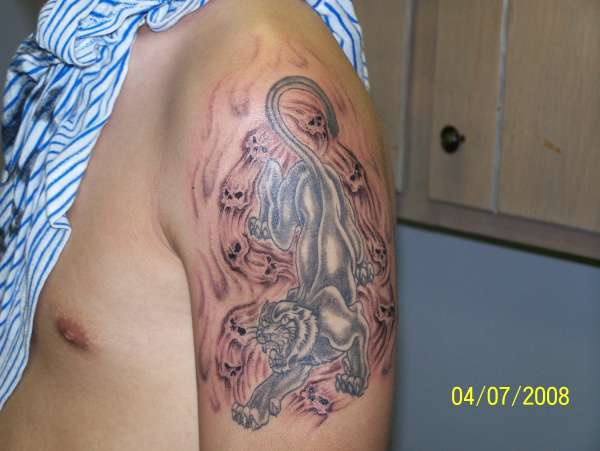 panther and skulls tattoo