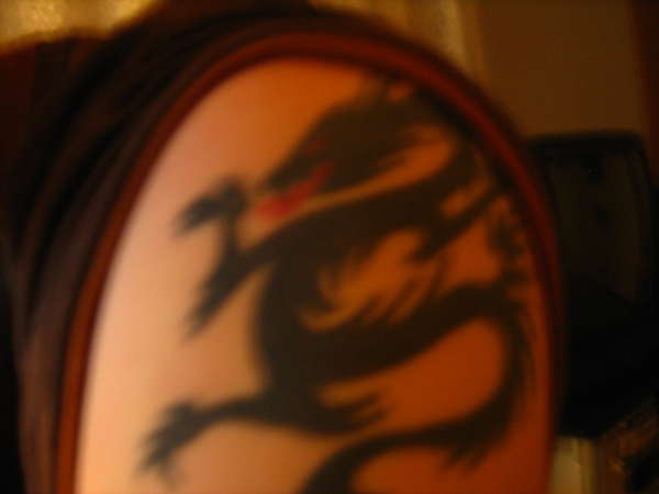 Dragon on left arm tattoo