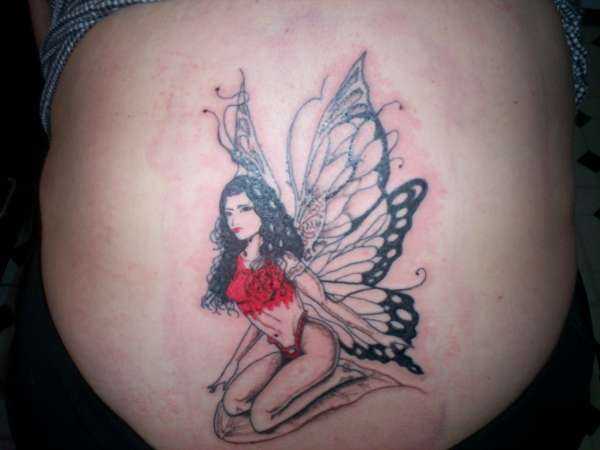 Fairy on base of spine tattoo