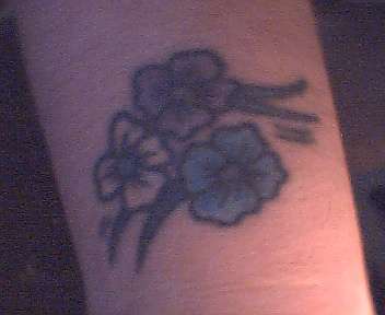 flowers on right wrist tattoo