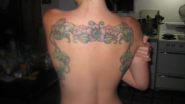 Crawling vines and flowers tattoo