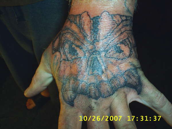 hand skull tattoo