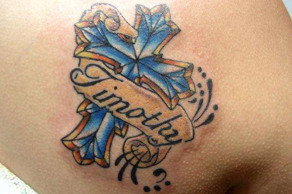 Blue cross and banner tattoo