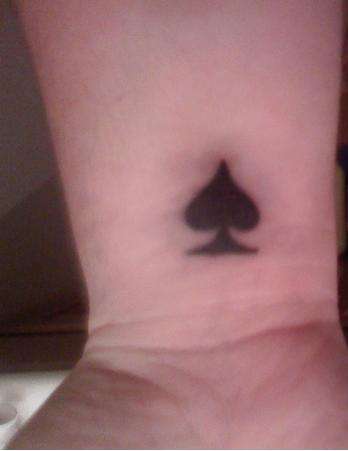 spade tattoo on finger meaning