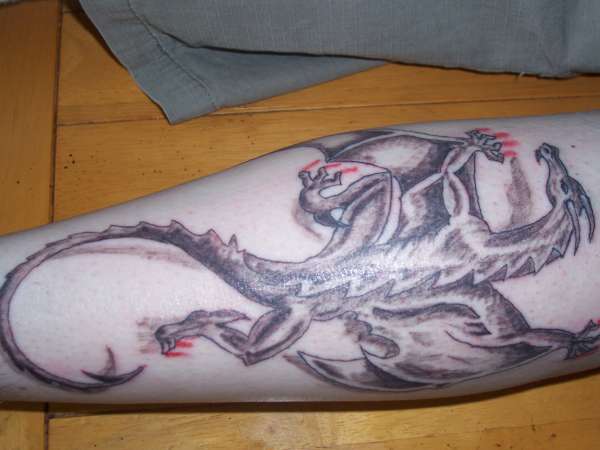 dragon on calf muscle tattoo