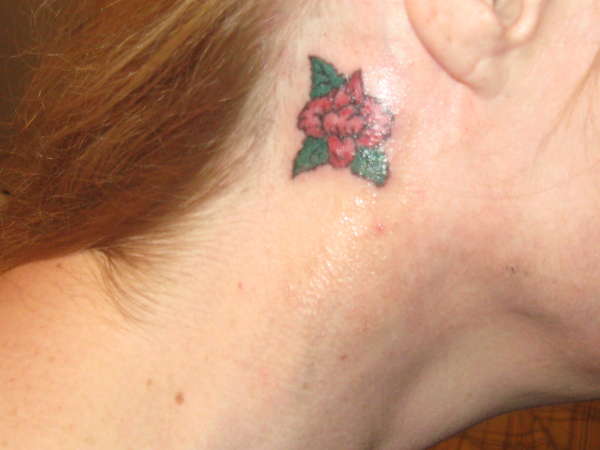 Rose behind right ear tattoo