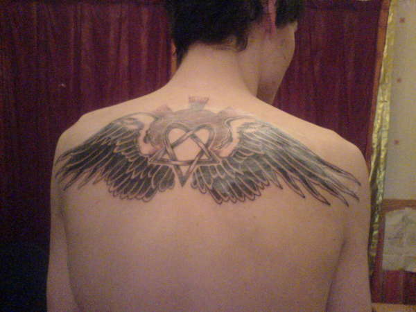 Heartagram with wings tattoo