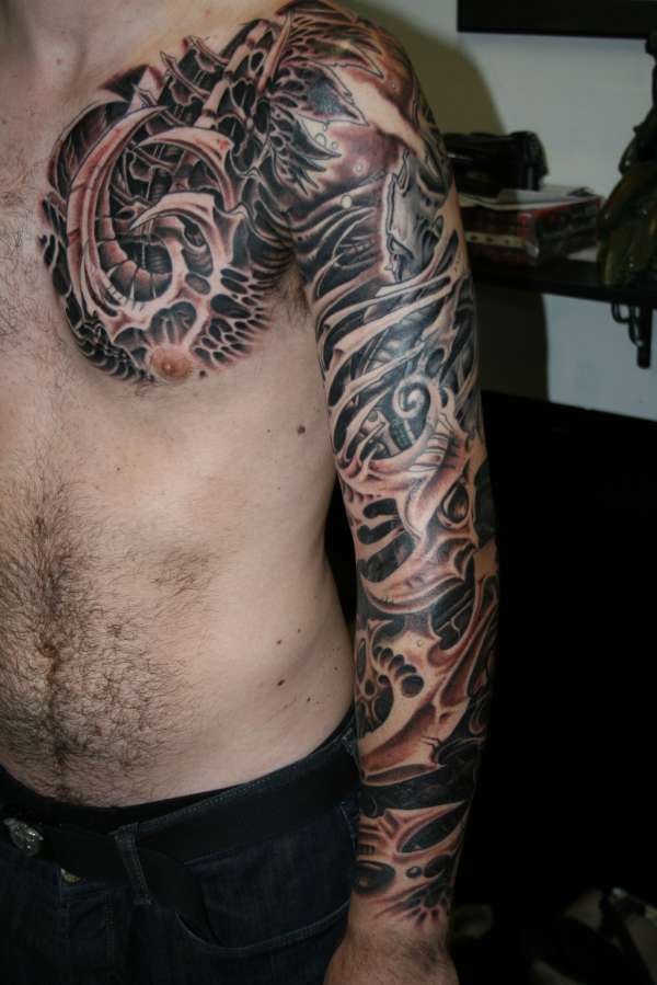 biomech arm and chest tattoo