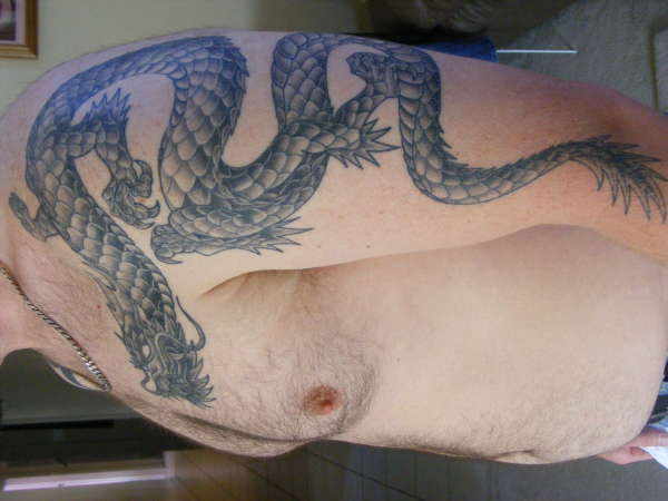 dragon on arm and shoulder tattoo