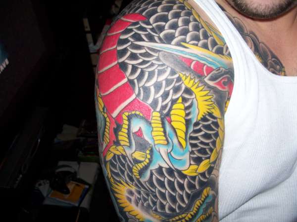 half sleeve from chest plate tattoo