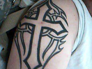 my cross with tribal behind it tattoo
