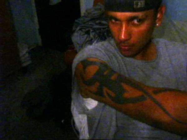 right arm covered with a sun god tribal tattoo