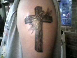 Cross on my left arm with7-25-99(the day i was baptised) in it tattoo